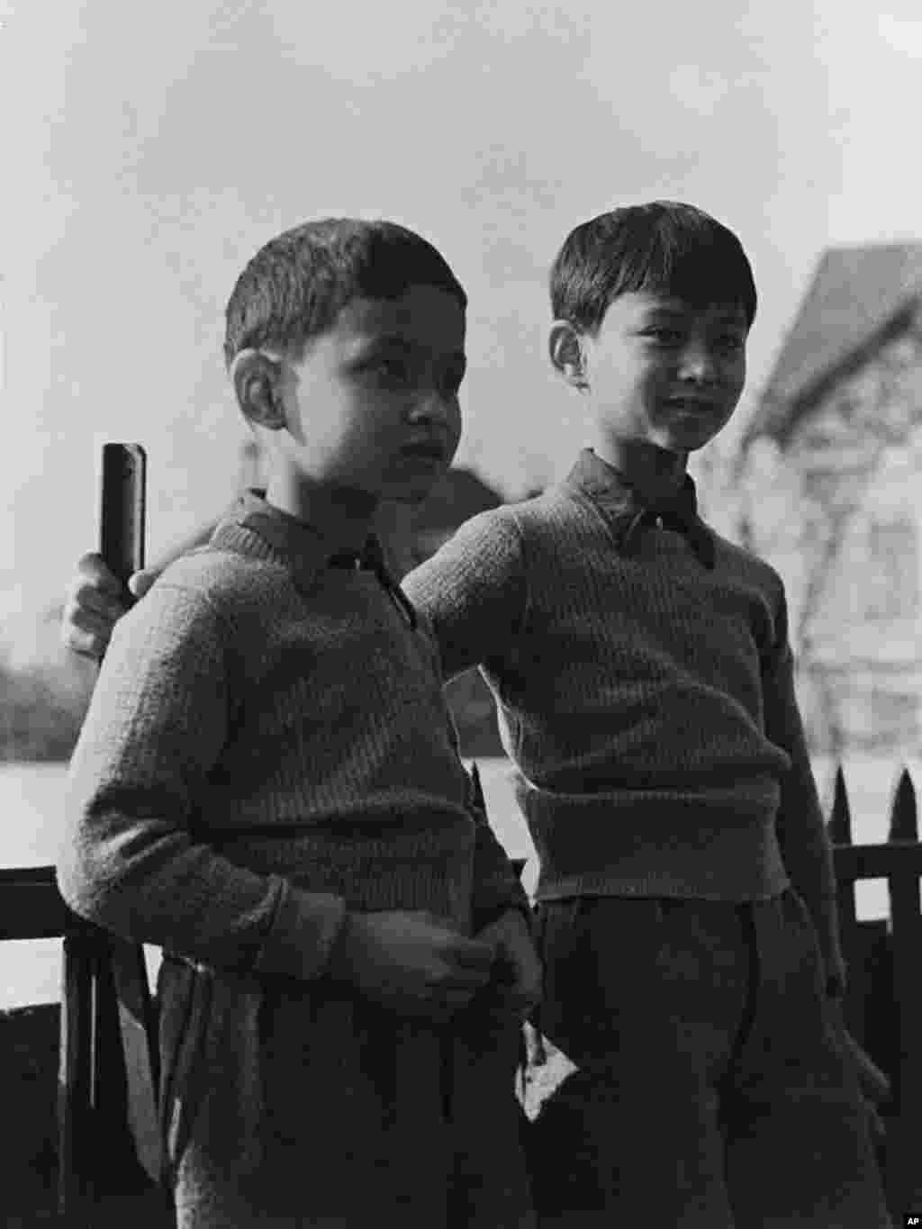 Thailand's Prince Bhumibol, left, now King Bhumibol Adulyadej, known as Rama IX, with his brother Prince Ananda, the former King Ananada Mahidol, in the grounds of the school in Lausanne Switzerland, on March 7, 1935.