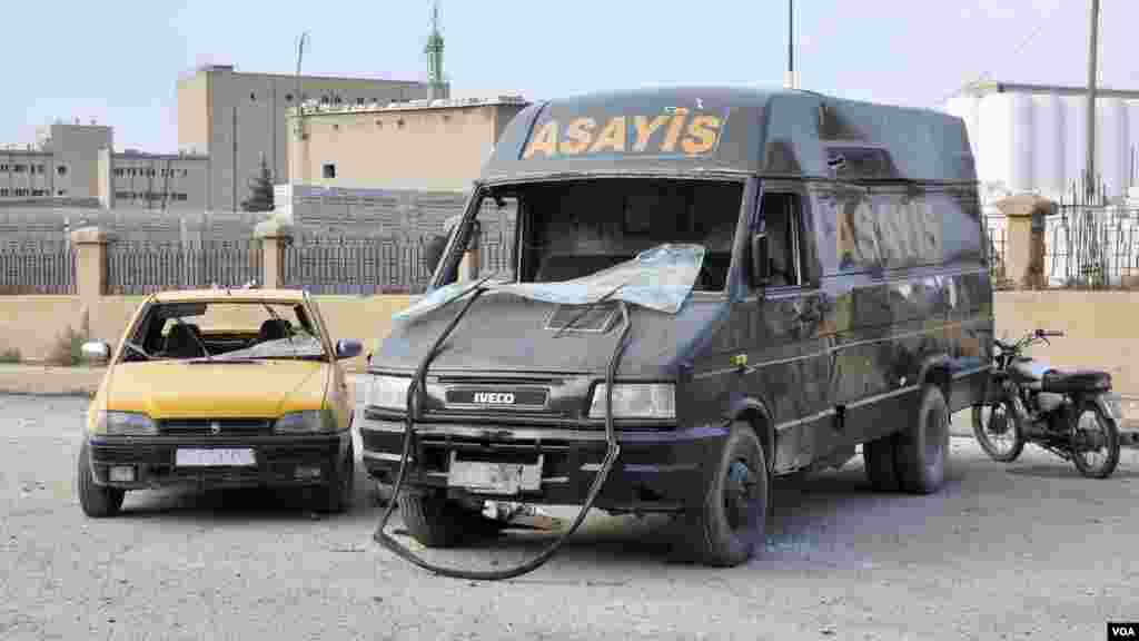 A Kurdish Security Forces vehicle is seen damaged from a suicide bombing in Qamishli, Nov. 25, 2013.