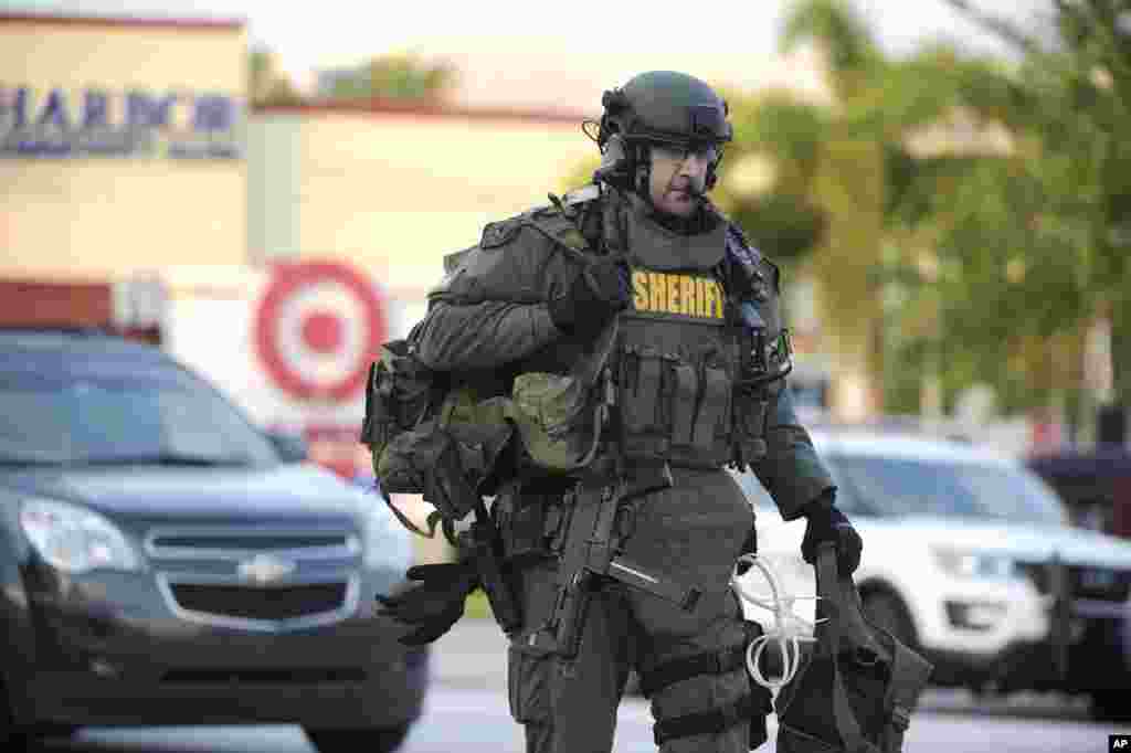 An Orange County Sheriff's Department SWAT member arrives at the scene of a fatal shooting at Pulse Orlando nightclub in Orlando, Florida, June 12, 2016.