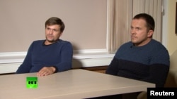A still image taken from video footage and released by Russia's RT international news channel, Sept. 13, 2018, shows two Russian men identified as Alexander Petrov and Ruslan Boshirov during an interview at an unnamed location. Bellingcat said on its website, Oct. 8, 2018, that the man British authorities identified as Alexander Petrov is actually Alexander Mishkin, a doctor working for the Russian military intelligence unit known as GRU.