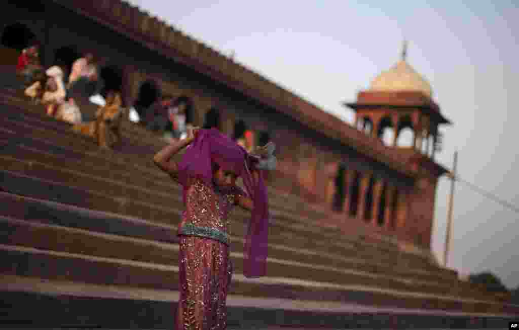A young Muslim girl adjusts her scarf as she descends the staircase of the Jama Masjid on International Day of the Girl Child in New Delhi, India, October 11, 2012.