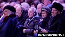 Holocaust survivors attend a ceremony at the Auschwitz-Birkenau Nazi death camp in Oswiecim, Poland, Monday, Jan. 27, 2020. 