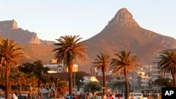 People enjoy sunset on a grass area well known for their walking trails in Cape Town, South Africa, Aug. 24, 2014.