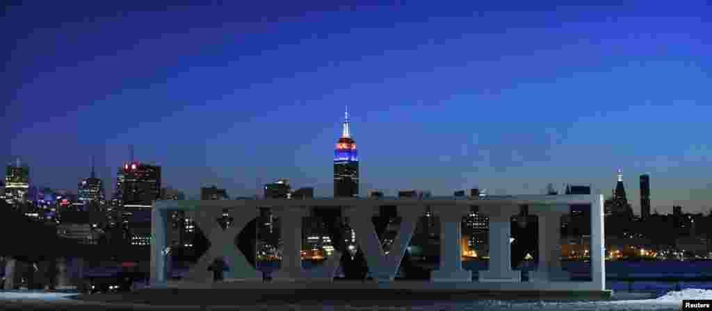 The New York skyline and the Empire State Building are seen in the distance as roman numerals for NFL Super Bowl XLVIII football game are displayed in Hoboken, New Jersey, Jan. 30, 2014.