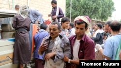 A man injured by an air strike on a market in Yemen's Saada province arrives at a hospital to receive medical attention, July 29, 2019. 