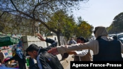 File - Taliban members violently attacked journalists during a restriction of media coverage during a women's rights protest in Kabul on October 21, 2021. (Photo by BULENT KILIC / AFP)