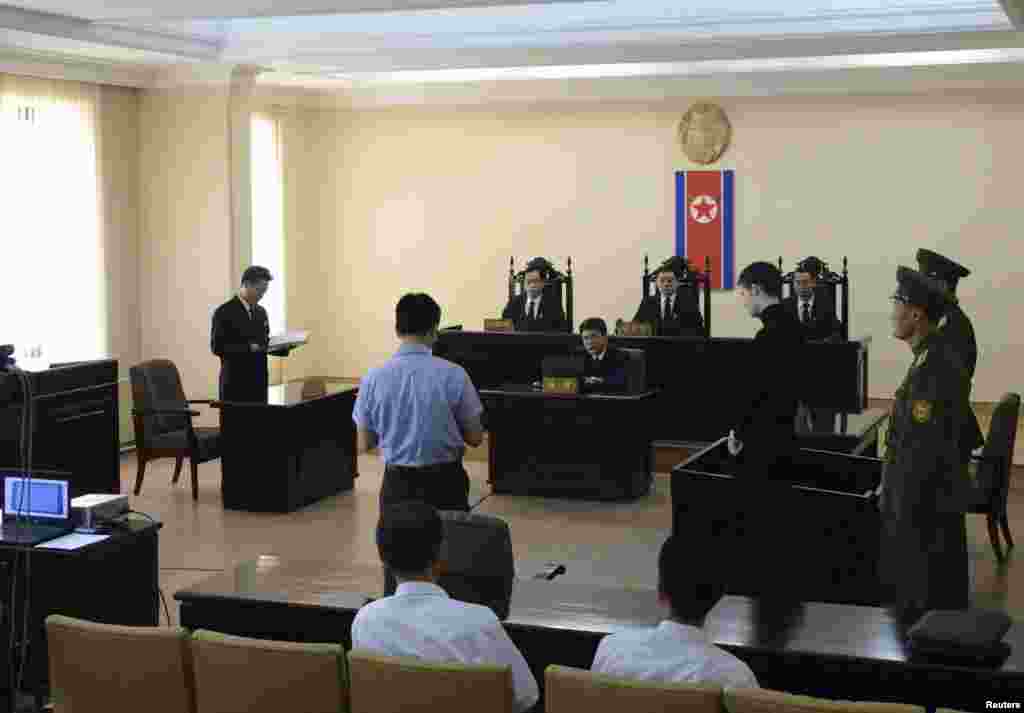 U.S. citizen Matthew Todd Miller (4th right) stands in a witness box during his trial at the North Korean Supreme Court in this undated photo released by North Korea's Korean Central News Agency (KCNA) in Pyongyang, Sept. 14, 2014.