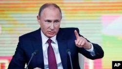Russian President Vladimir Putin gestures during his annual news conference in Moscow, Russia, Thursday, Dec. 14, 2017.