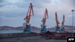 Cranes plus North Korean and Russian coal bound for China are seen at the RasonConTrans coal port at Rajin harbor in the Rason Special Economic Zone, Nov. 21, 2017.