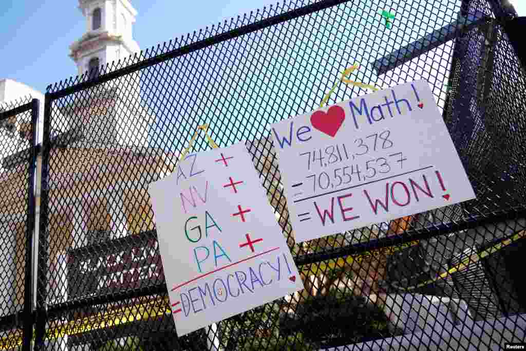 Posters displaying election results hang on the fence outside of St. John's Church near the White House, in Washington, Nov. 8, 2020.