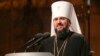 A new head of independent Ukrainian church Metropolitan of Kiev Epiphanius greets people gathered to support independent Ukrainian church near the St. Sophia Cathedral in Kyiv, Dec. 15, 2018. 