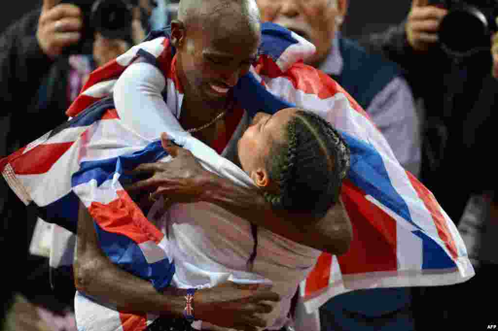Britain's Mohamed Farah celebrates with his daughter Rihanna after winning the men's 10,000m final at the athletics event of the London 2012 Olympic Games on August 4, 2012 in London.