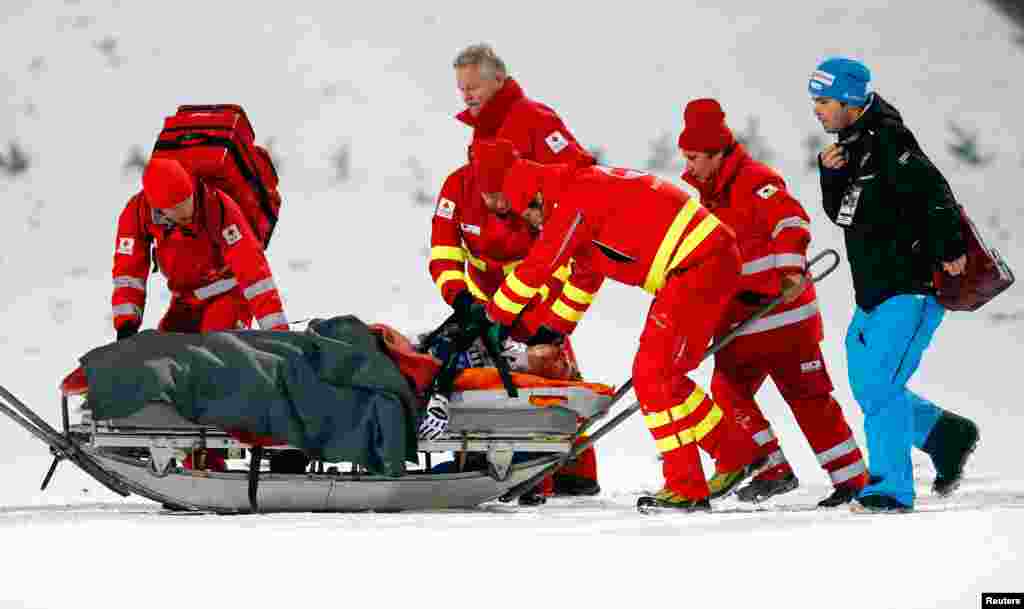 Simon Ammann from Switzerland is carried out of the finish area after he crashed during the final jumping of the 63rd four-hills ski jumping tournament in Bischofshofen, Austria.