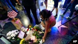 Flowers are placed in memory of actor and comedian Robin Williams on his Walk of Fame star in Hollywood, Monday, Aug. 11, 2014. 