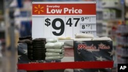 FILE - Towels are seen on display on a sale rack at a Walmart store in Rogers, Arkansas.