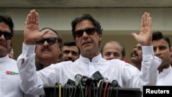 Cricket star-turned-politician Imran Khan, chairman of Pakistan Tehreek-e-Insaf (PTI), speaks to members of media after casting his vote at a polling station during the general election in Islamabad, Pakistan, July 25, 2018.
