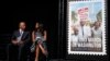 Actress Gabrielle Union and Congressman John Lewis sit on stage at the Newseum in Washington, D.C., at the unveiling of a U.S. Postal Service stamp commemorating the 50th anniversary of the March on Washington, Aug. 23, 2013.
