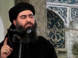 FILE - This image made from video posted on a militant website July 5, 2014, purports to show the then-leader of the Islamic State group, Abu Bakr al-Baghdadi, delivering a sermon at a mosque in Iraq.