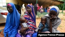 FILE - Victims Maryam Aliyu, center, Rabi Sa'adu, left, and Fatima Sal'Hatu describe their ordeals with bandits at Bini primary health clinic, Wamako district of Sokoto, northwest Nigeria, Sept. 22, 2021. 