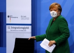 German Chancellor Angela Merkel arrives for the National Integration Summit at the Chancellery in Berlin, Germany, Oct. 19, 2020.