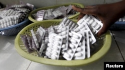 FILE - Ruth Munyao, a pharmacist, dispenses antiretroviral drugs at the Mater Hospital in Kenya's capital of Nairobi, Sept. 10, 2015. 