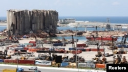 FILE PHOTO: Vehicles drive near the grain silo that was damaged during Beirut port explosion, in Beirut, Lebanon April 9, 2021.