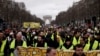 FILE - Yellow Vests protesters march on the Champs Elysees avenue in Paris. France's yellow vest protesters remain a force to be reckoned with five months after their movement started, and as President Emmanuel Macron announces his responses to their grievances, March 2, 2019.
