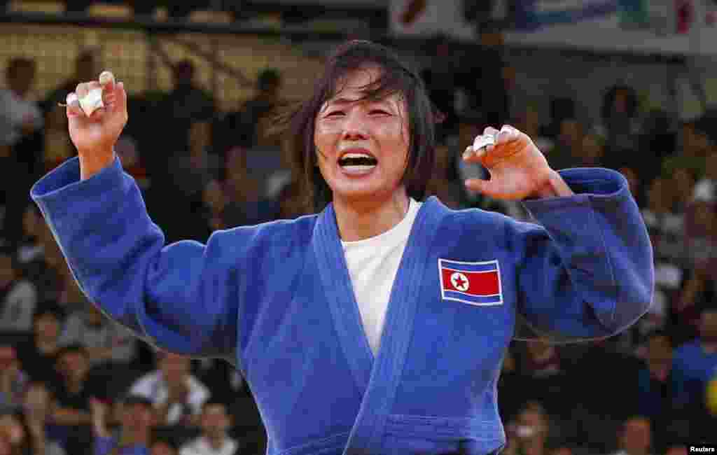 North Korea's An Kum Ae celebrates after defeating Cuba's Yanet Bermoy Acosta in their women's -52kg final judo match at the London 2012 Olympic Games July 29, 2012.