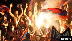 FILE - Russian soccer fans are seen chanting at a match at the Arena Khimki outside Moscow.