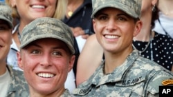U.S. Army 1st Lt. Shaye Haver, left, and Capt. Kristen Griest pose for photos with other female West Point alumni after Ranger school graduation at Fort Benning, Ga., Aug. 21, 2015. 