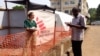 CDC epidemiologist Meredith Dixon confers with another physician at the Doctors Without Borders Ebola treatment center at Donka hospital in Conakry, Guinea, Dec. 19, 2014.