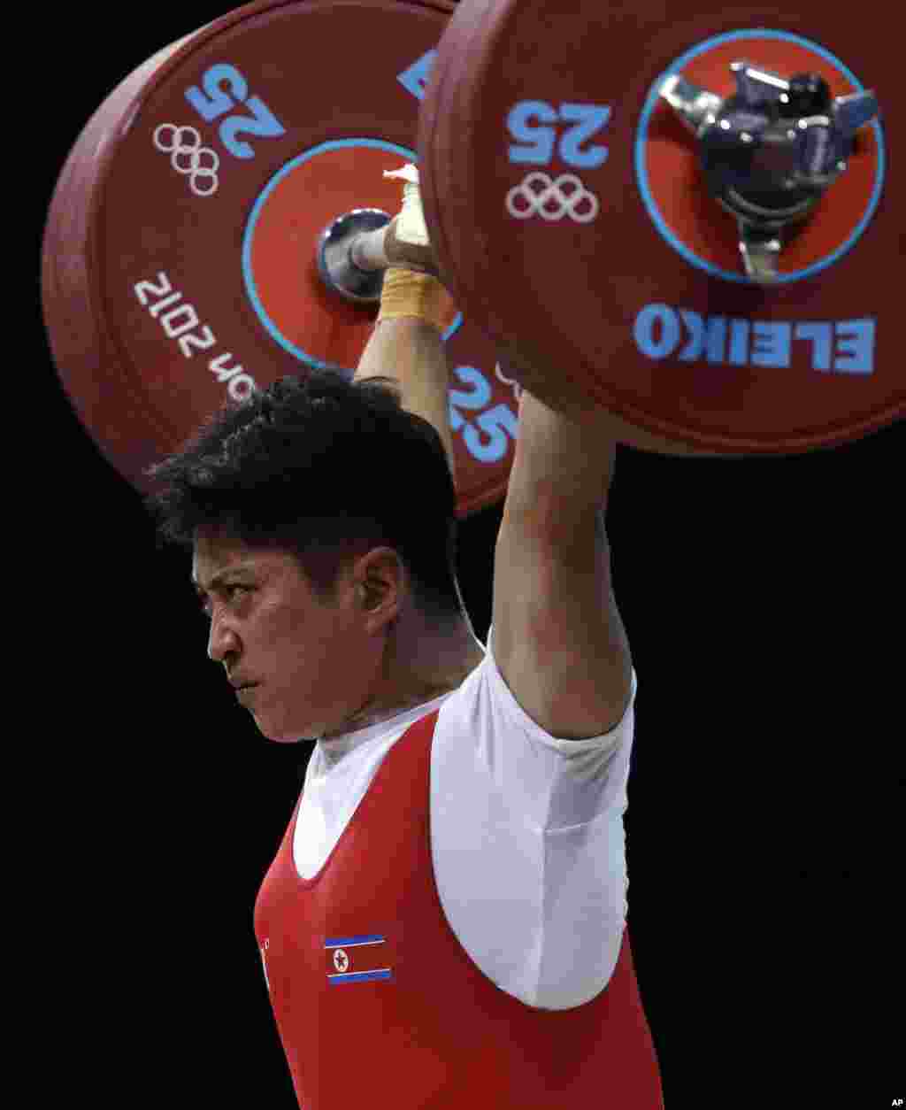 Kim Kum Sok of North Korea competes during the men's 69-kg weightlifting competition at the 2012 Summer Olympics, July 31, 2012.