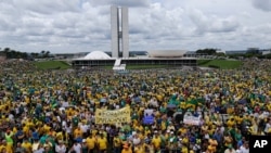 Thousands of demonstrators take part in a protest against the government of Brazil's President Dilma Rousseff, in front of the Brazilian National Congress, in Brasilia, Brazil, Sunday, March 15, 2015.