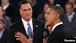 U.S. President Barack Obama (R) speaks as Republican presidential nominee Mitt Romney (L) listens during the second U.S. presidential debate in Hempstead, New York, October 16, 2012.