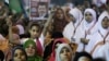 A young girl flies an Egyptian national flag as she listens to Mohammed Mursi, the Muslim Brotherhood's presidential candidate, at a rally in Cairo, May 20, 2012.