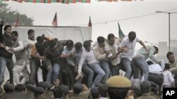 Communist Party of India (Marxist) activists raise slogans at a protest against inapt handling by the central government of alleged corruption charges pertaining to the Commonwealth Games, the Adarsh Society land scam and the 2-G telecom scam, in New Delh