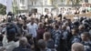 WBC Heavyweight Champion Vitali Klitschko, center in white t-shirt, talks to riot police at an opposition protest rally in front of the Ukrainian House in central Kiev, Ukraine, July 4, 2012.