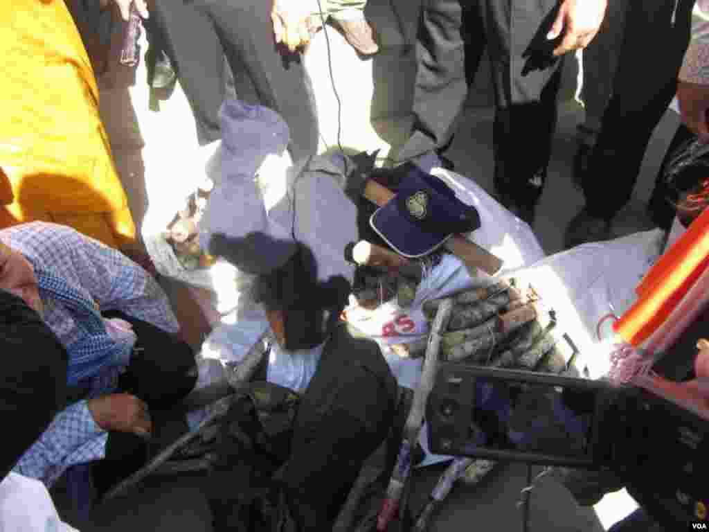Caps, clothes and wooden batons allegedly belonging to security guards were found after the guards left them and ran away, Phnom Penh, Cambodia, July 15, 2014. (Khoun Theara/VOA)