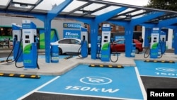 FILE - Electric vehicle charging units are pictured at newly opened MFG (Motor Fuel Group) EV Power service station in Manchester, Britain, August 31, 2021.