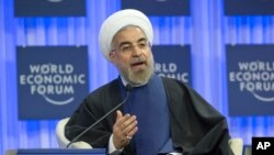 Iranian President Hassan Rouhani, gestures as speaks during a session of the World Economic Forum in Davos, Switzerland, Jan. 23, 2014.