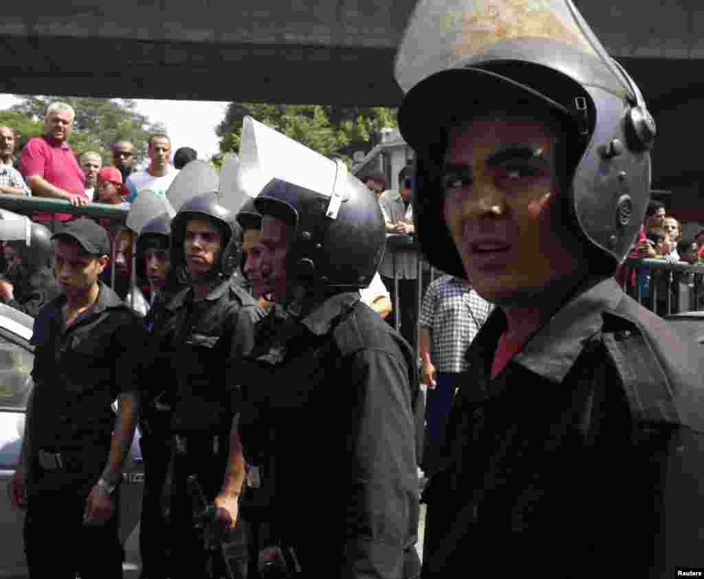 Police stand guard at the site of a bomb blast in Cairo.