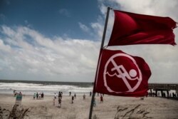 Red flags to indicate that the ocean has a high tide and locals should not be swimming due to danger are seen at Jacksonville Beach before Hurricane Dorian, in Jacksonville, Florida, Sept. 3, 2019.
