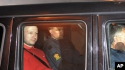 Norway's twin terror attacks suspect Anders Behring Breivik, left, sits in an armored police vehicle after leaving the courthouse following a hearing in Oslo, July 25, 2011 where he pleaded not guilty to one of the deadliest modern mass killings in peacet