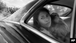 In this image released by Netflix, Yalitza Aparicio in a scene from "Roma" by Alfonso Cuarón. On Tuesday, Aparicio was nominated for an Oscar for Best Actress for her work in the film. (Netflix via AP)