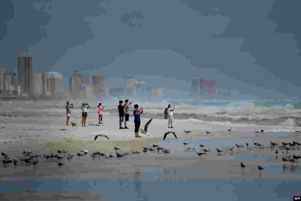 People look out to the Gulf of Mexico as Hurricane Michael approaches, Oct. 9, 2018, in Panama City Beach, Florida.