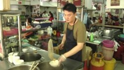Alex Lee runs a wonton noodle stall at a popular open-air food court in Kuala Lumpur. Lee, a smoker for two decades, supports enforcement of the smoking ban at all eateries nationwide. "People should have clean air while they eat," he says.