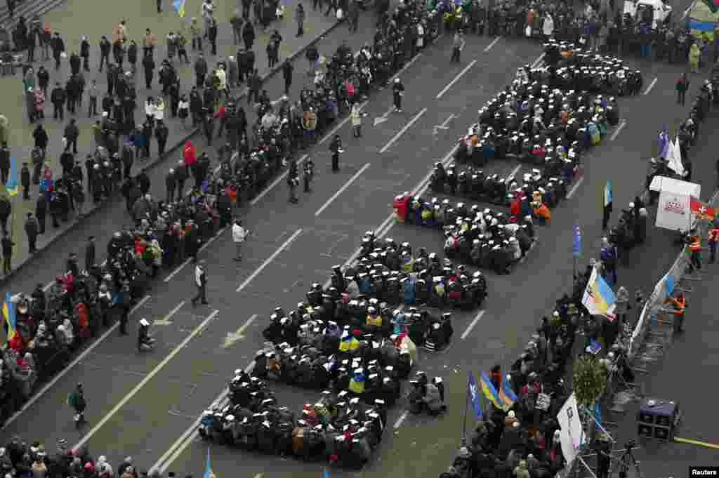 Pro-European integration protesters form the Ukrainian word for "Lustration" at Independence Square in Kyiv.