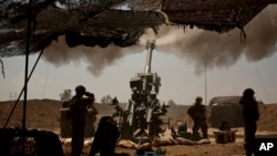 U.S. soldiers from the 82nd Airborne Division fire artillery in support of Iraqi forces fighting Islamic State militants from their base east of Mosul on Monday, April 17, 2017. 