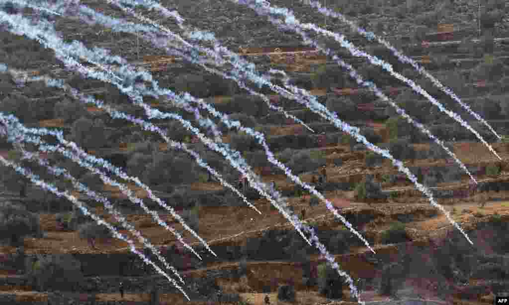 Palestinian protesters and Israeli security forces clash following a demonstration against settlements in the village of Beita in the occupied West Bank.