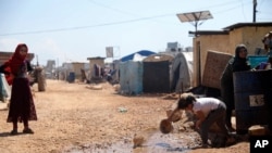 FILE - This April 19, 2020, photo shows a large refugee camp on the Syrian side of the border with Turkey, near the town of Atma, in Idlib province, Syria.
